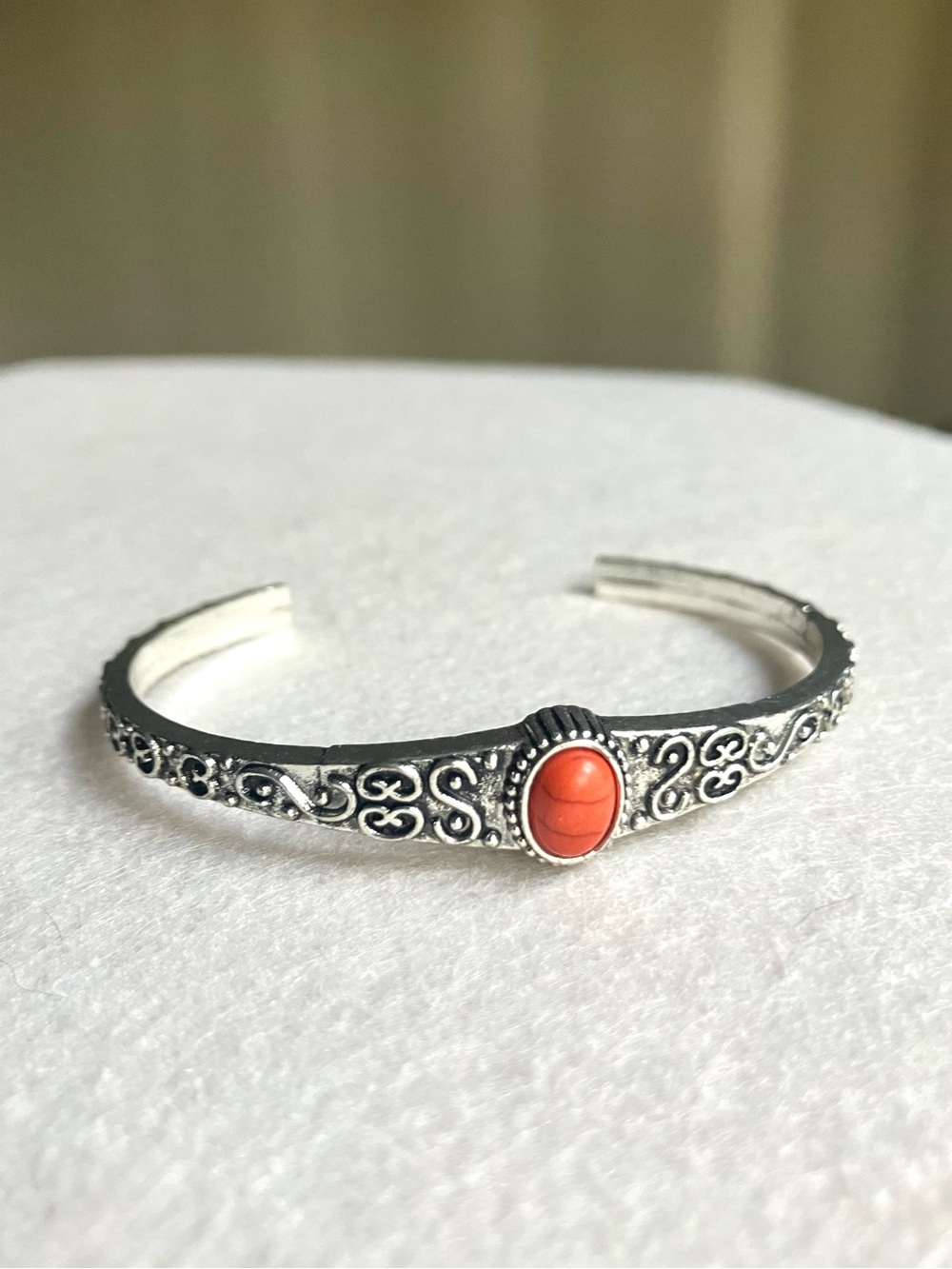 Small embossed cuff bracelet with orange stone